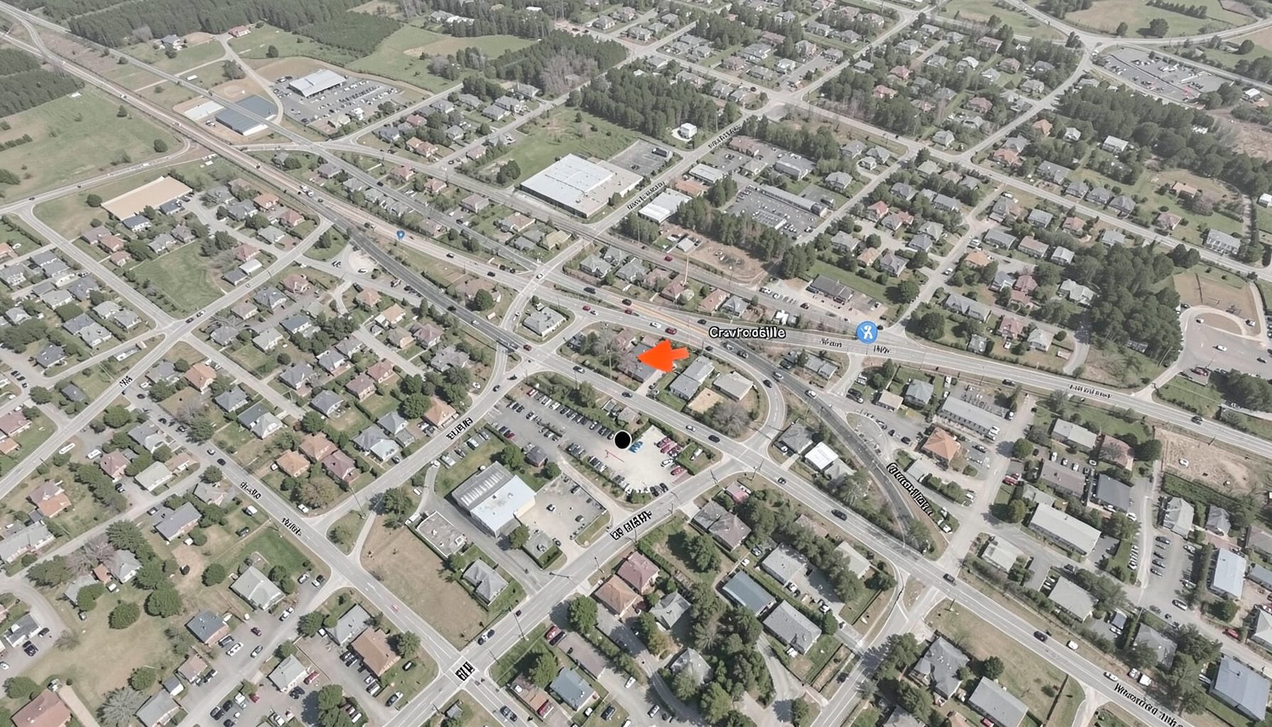 Aerial-style neighborhood map showing the Speedway area west of Indianapolis with major roads and the facility location near Crawfordsville Road, rendered in muted earth tones and soft grays.